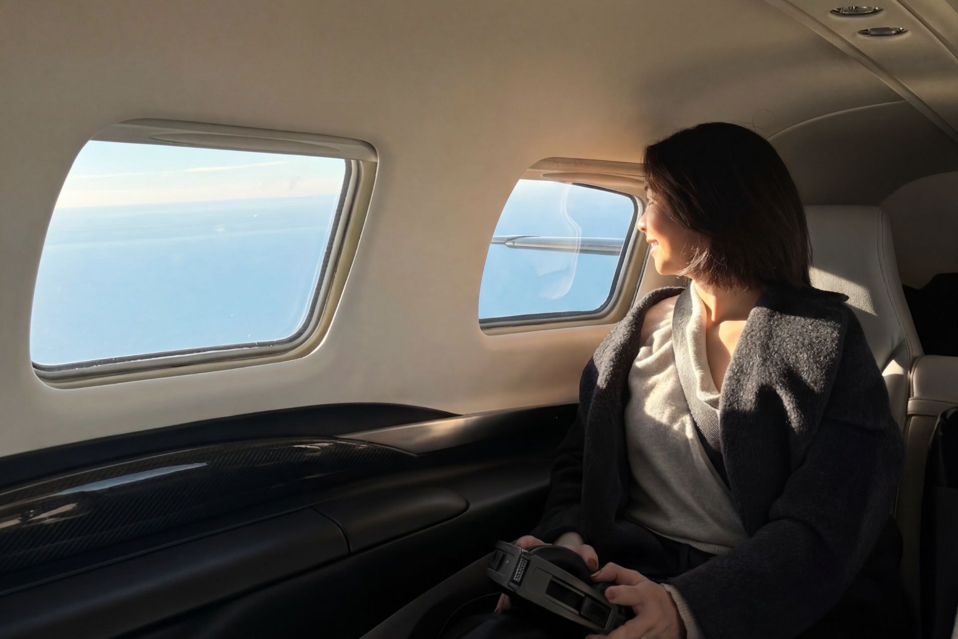 Piper Meridian cabin: passenger looking out the window mid‑flight