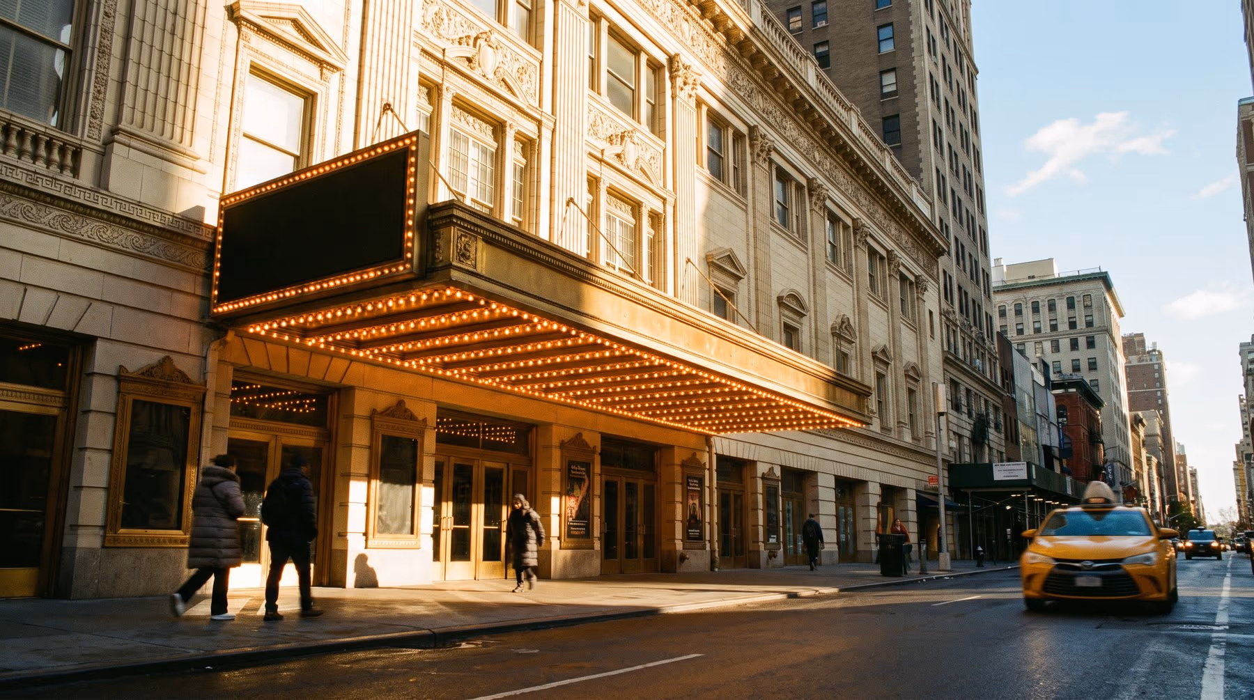 A Broadway theatre marquee in afternoon light