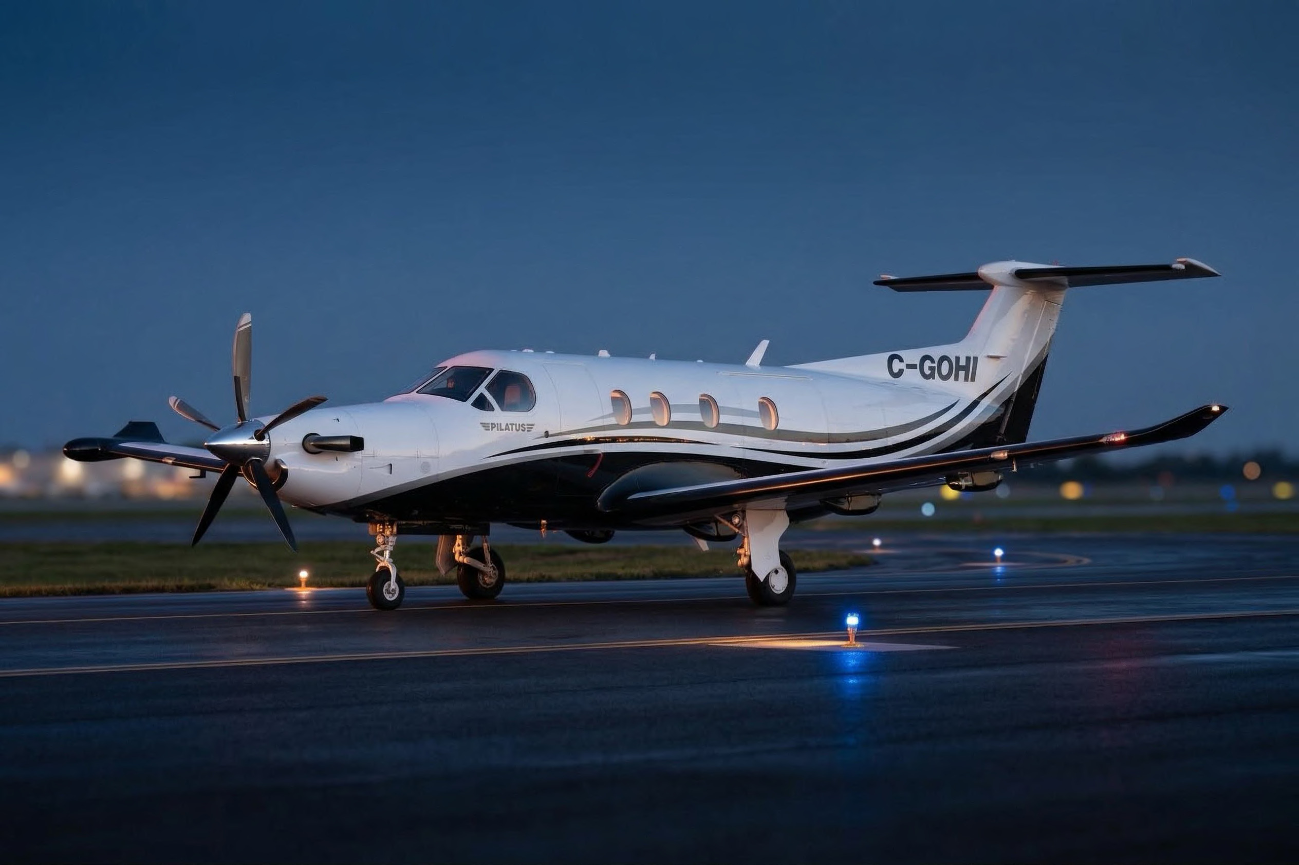 NectAir C-GOHI Pilatus PC-12 on the ramp at dusk